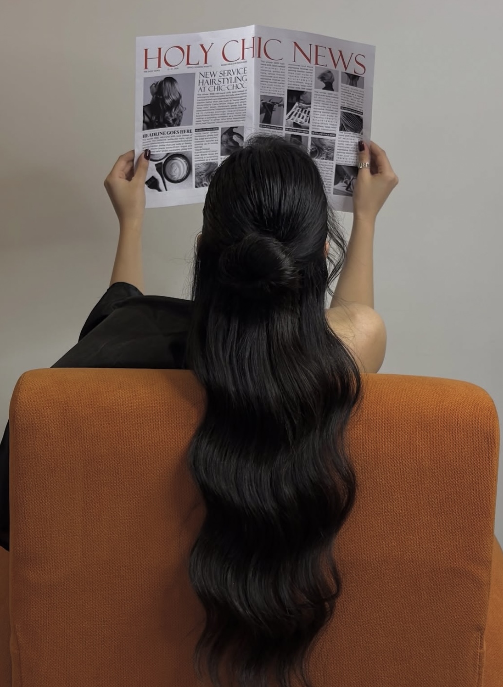 Woman reading a newspaper with elegant salon hair